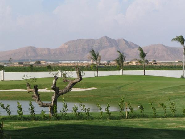 The mountain is called “ big head “
Golf course with aquatic obstacle and sand bunker. Behind the limitation wall of the golf resorts is the mountain looking like a big head.
